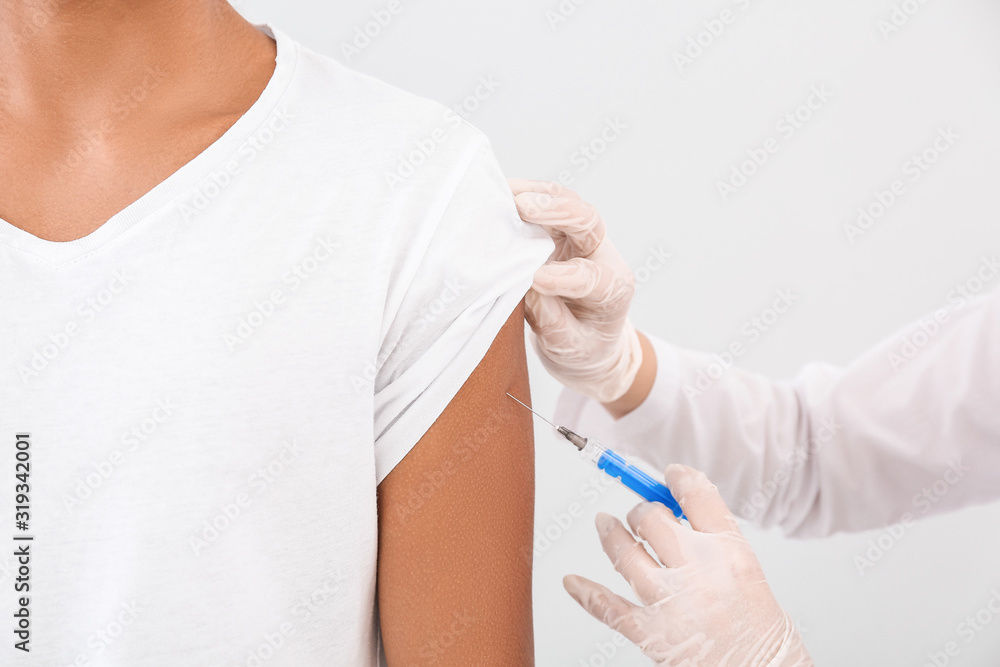 Doctor vaccinating teenage boy on white background, closeup Doctor vaccinating teenage boy on white background, closeup