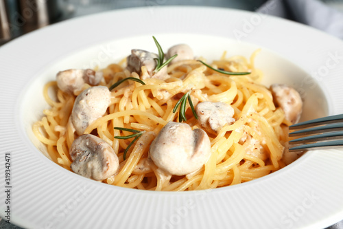 Plate with tasty pasta and mushrooms, closeup