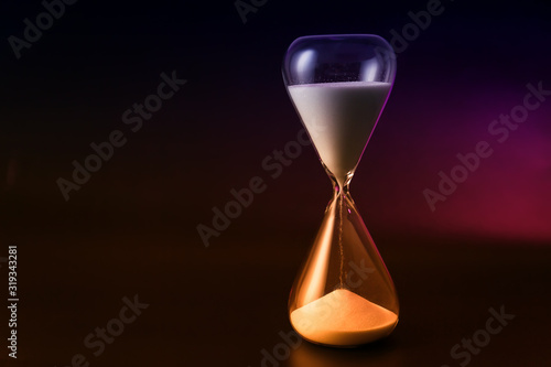 Hourglass on dark background. Time management concept