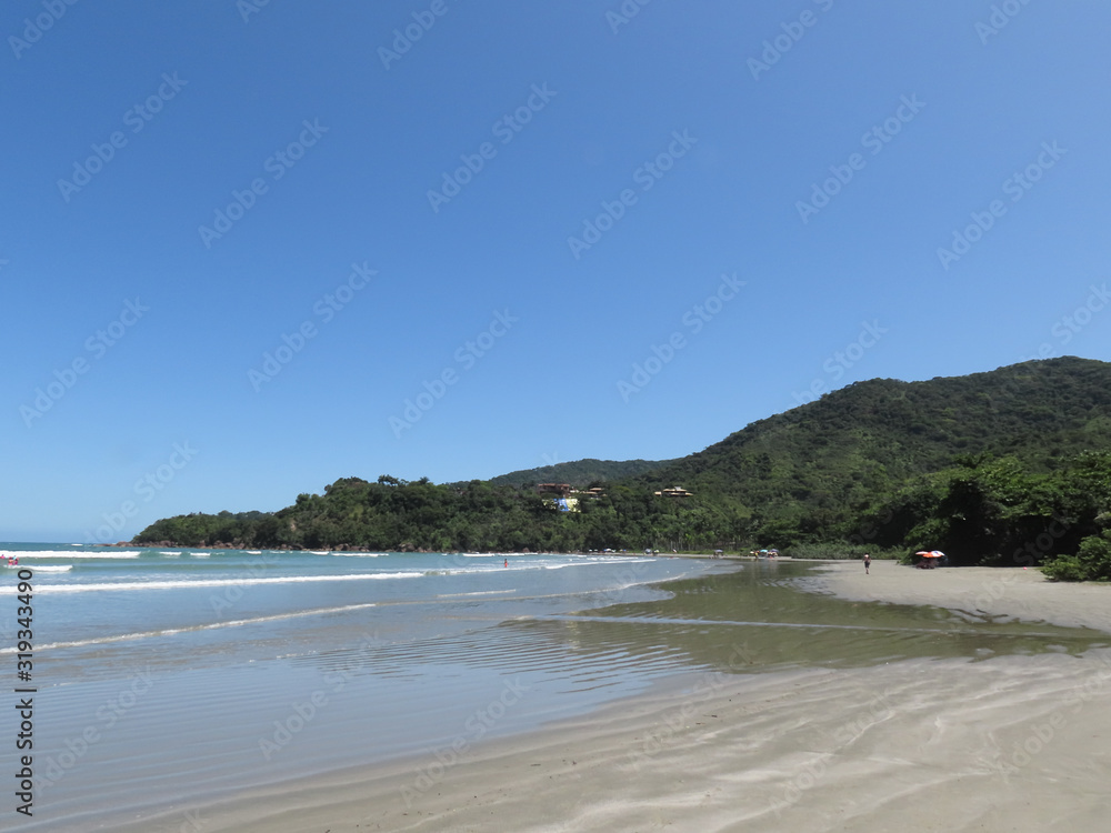 Sea, sand, mountains, sun and blue sky. Beach in the city of Ubatuba. Interior of São Paulo. Brazil. Sea, sand, mountains, sun and blue sky. Beach in the city of Ubatuba. Interior of São Paulo. Brazil.
