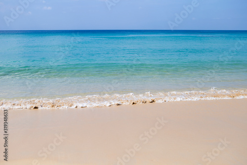 Beatiful clean beach with blue sea water, summer outdoor day light, holiday and vacation destination, nature background, tropical climate