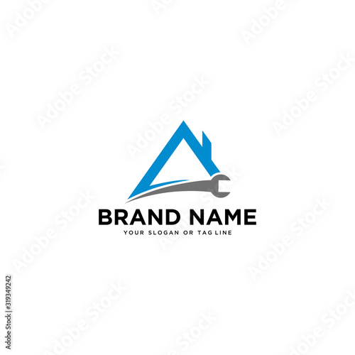 logo design wrench and house building vector
