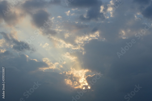 The light from the sun shining through the clouds