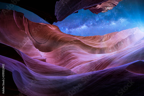 Antelope Canyon's red rock formations under a midnight blue evening sky in Page, Arizona, USA.