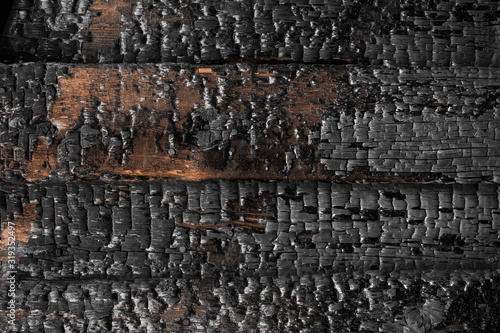 Beautiful charred wooden wall texture. Burned scratched hardwood surface. Smoking wood plank background. Dark Burned wooden texture empty horizontal surface, copy space