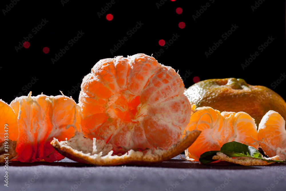 orange tangerine ,citrus reticula on table black background back light