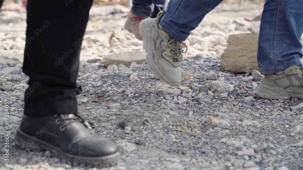 close-up of feet walking on gravel slow motion close-up of feet walking on gravel slow motion