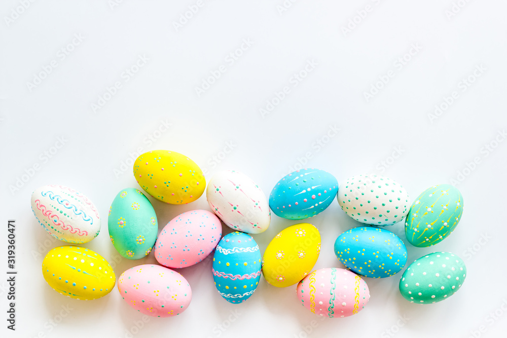 Easter eggs painted in pastel colors on white background top-down copy space Easter eggs painted in pastel colors on white background top-down copy space