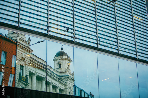 reflection of old building in glass window