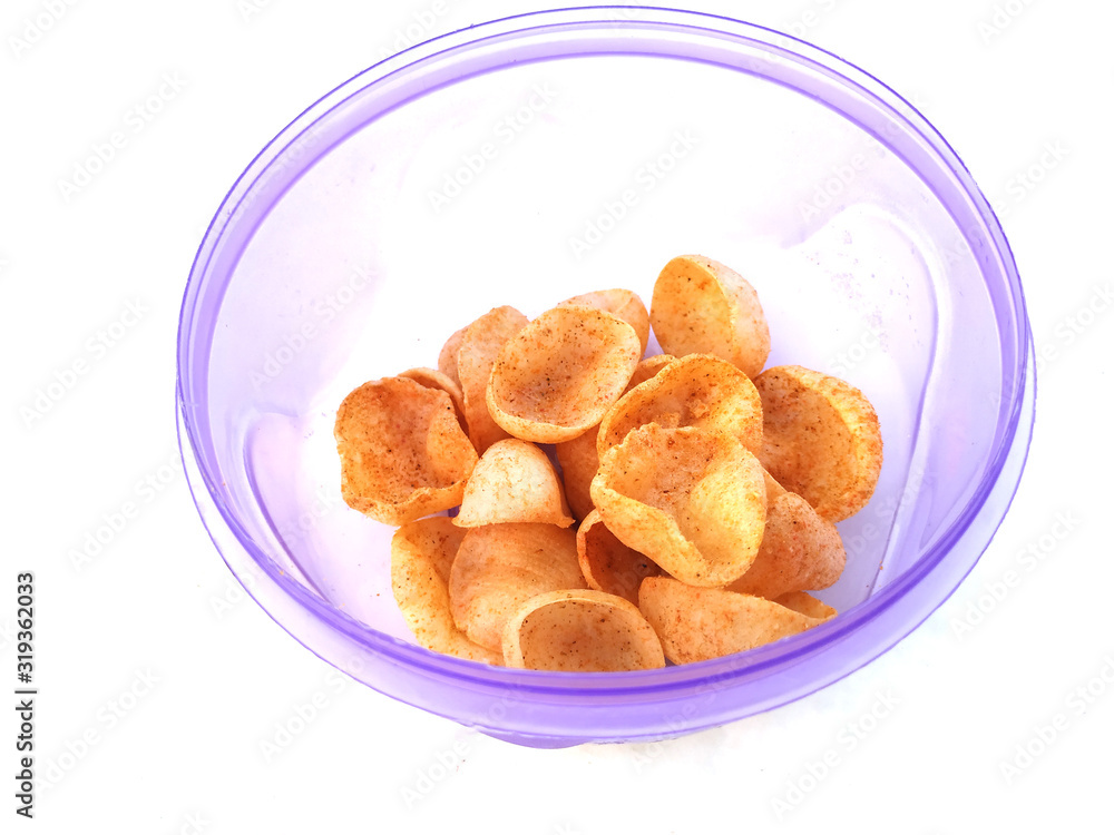 some yellow eatable food put in blue plastic bowl isolated on white background some yellow eatable food put in blue plastic bowl isolated on white background