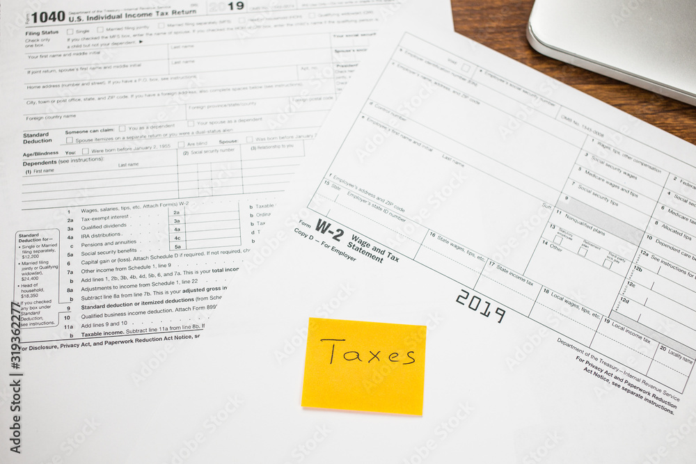 custom made wallpaper toronto digitalYellow Paper Note With Words Taxes on a blank IRS Tax return1040 for 2019 on a wooden table. Individual Income Tax Return. The time to pay taxes