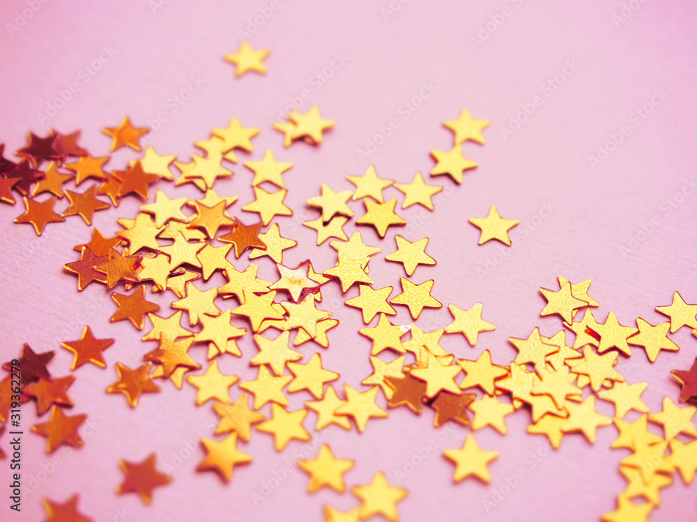 Golden stars glitter on pink background