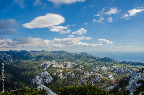 View of mountains, sky and sea in Croatia, Northern Velebit National Park. Scenic mountain landscape. Rocky mountains picturesque nature.