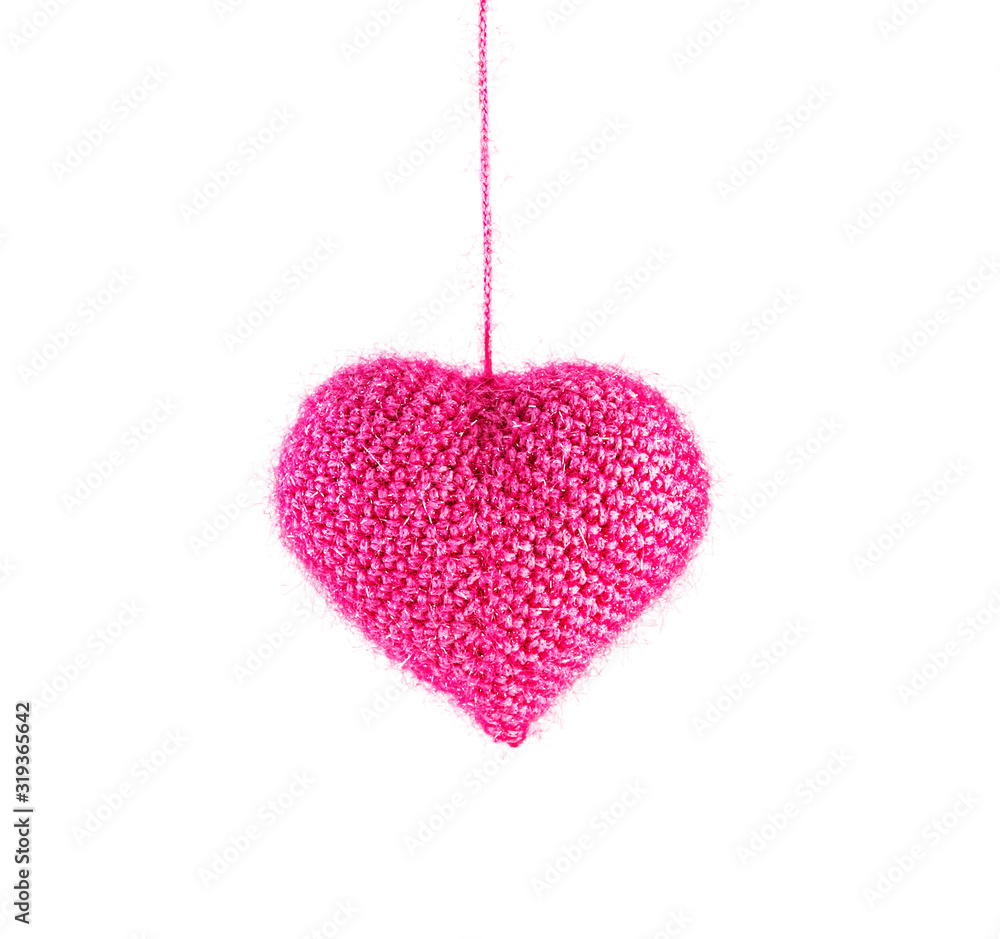 Beautiful knitted pink heart, christmas toy hanging isolated on white