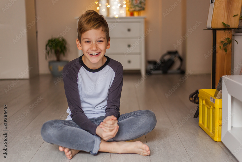 Happy little boy relaxing on floor at home. Happy little boy relaxing on floor at home.