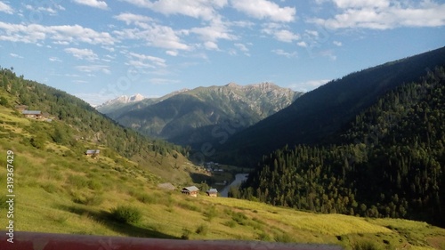 a view of village and mountains in a valley