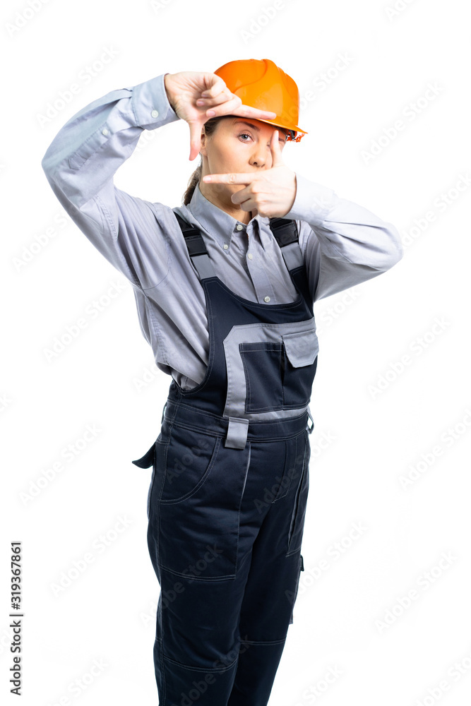 Girl in a construction helmet makes measurements with hand gestures. isolated Girl in a construction helmet makes measurements with hand gestures. isolated