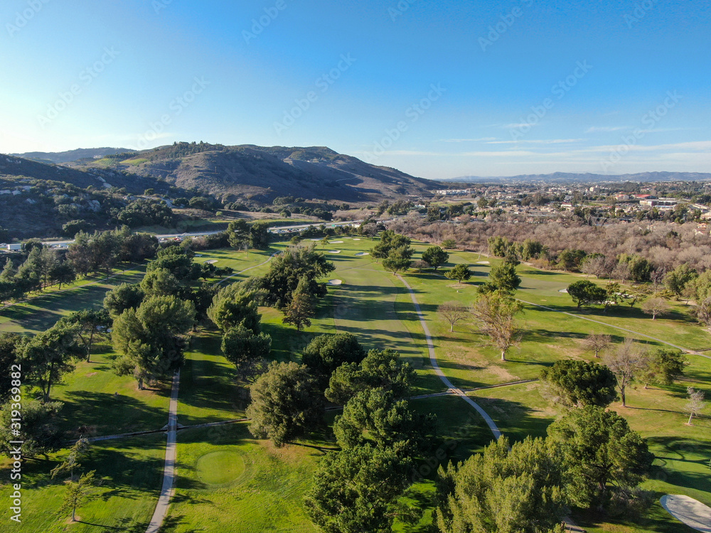 Obraz premium Aerial view of golf course with green field in the valley. Green turf scenery. Temecula, California, USA