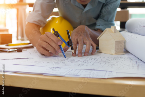 Engineer man and Architect drawings blueprint at Construction Site.Home Project to Offer Management