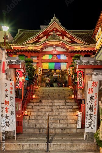 Buddhist Tokudaiji temple in the Ameyoko street of Tokyo at night.