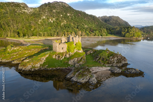 Photography Aerial drone shot of Castle Tioram, Scottish Highlands.