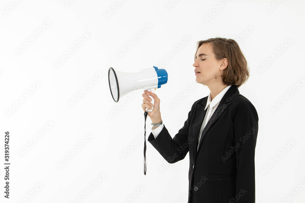Young business woman is shouting through a megaphone on white isolated background. Young business woman is shouting through a megaphone on white isolated background.