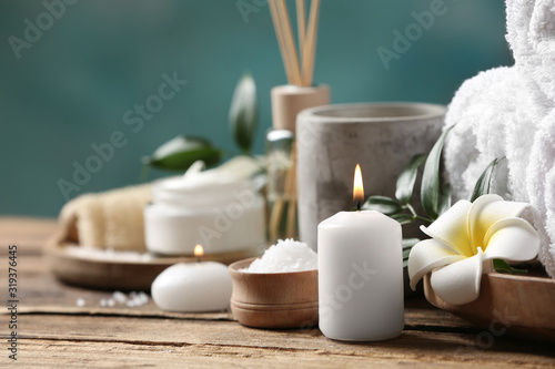 Beautiful spa composition with plumeria flower on wooden table  closeup