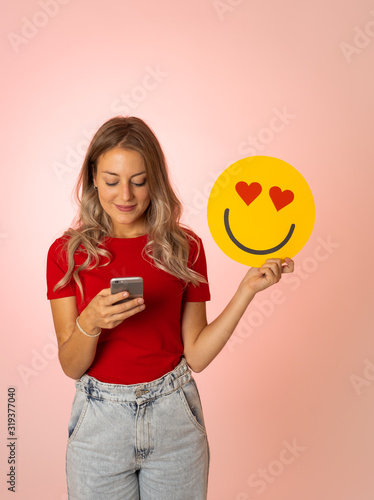 Beautiful young woman holding In Love and Like face emoji emoticon. In social media notification icon