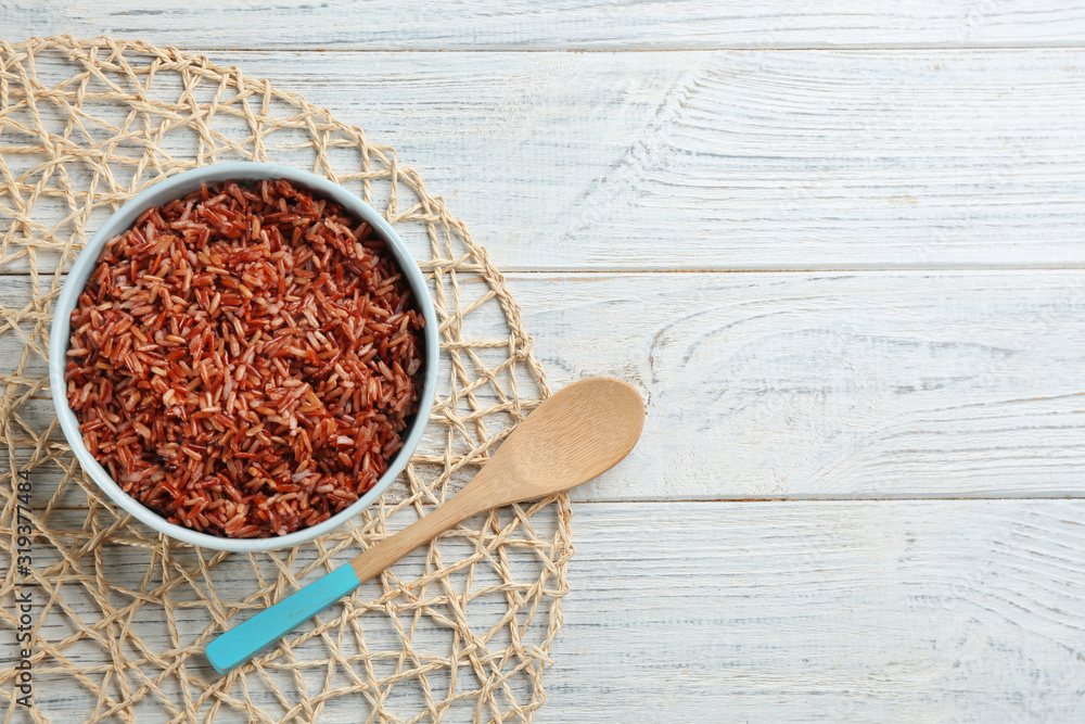 Delicious brown rice served on white wooden table, flat lay. Space for text Delicious brown rice served on white wooden table, flat lay. Space for text
