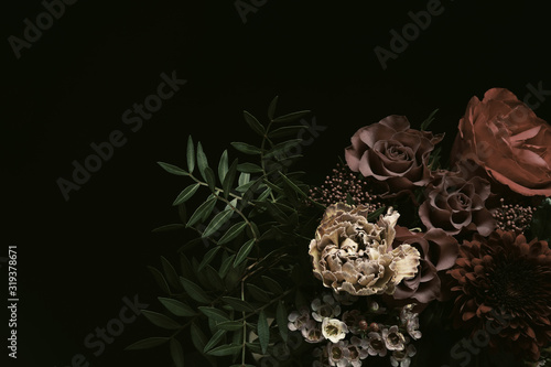 Beautiful fresh flowers on black background. Floral card design with dark vintage effect © New Africa