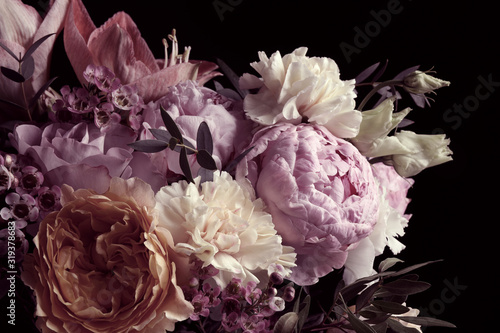Beautiful bouquet of different flowers on black background. Floral card design with dark vintage effect photo