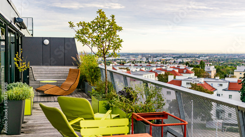 Quadro em tela Rocking lounger on a roof terrace with bamboo and grasses and outdoor furniture