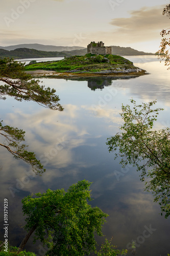 Aerial drone shot of Castle Tioram, it is a ruined castle that sits on the tidal island Eilean Tioram in Loch Moidart, Lochaber, Highland, Scotland. It is located west of Acharacle. photo