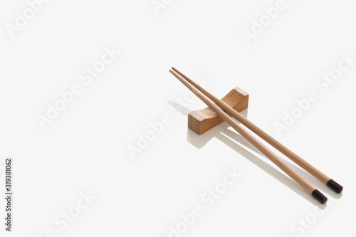 Wooden pairs of chopsticks on white background. cooking culture in Asian countries. photo