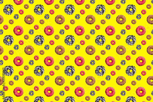 Fototapeta Naklejka Na Ścianę i Meble -  Pattern of pink and chocolate donuts on bright yellow background top view, tasty doughnuts backdrop, colorful sweet dessert wallpaper, repeating decorative ornament, delicious cake art design