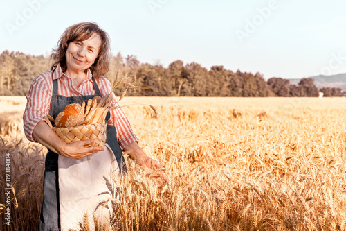 Wallpaper Mural Woman with a basket of fresh home baking being in a wheat field. Golden ears of corn before harvest and a lady from the farm. Sunlight in the frame. Torontodigital.ca