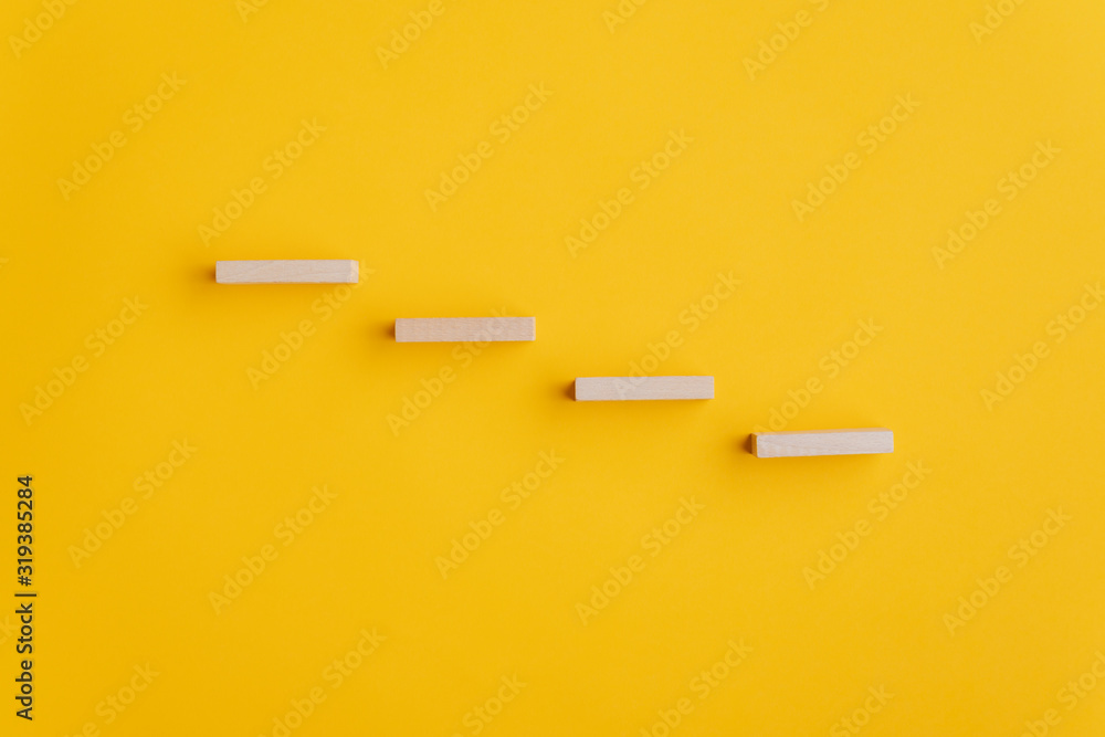Four blank wooden pegs placed in a stairway like structure - obrazy, fototapety, plakaty 