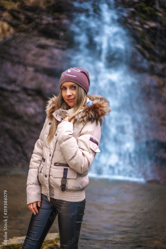 Cascada Uguna, Bizkaia / Spain »; January 20, 2020: A blonde in the natural park at the waterfall very cold Cascada Uguna, Bizkaia / Spain »; January 20, 2020: A blonde in the natural park at the waterfall very cold