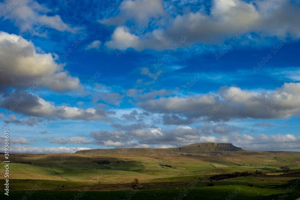 Sun lights up clouds around penyghent Sun lights up clouds around penyghent
