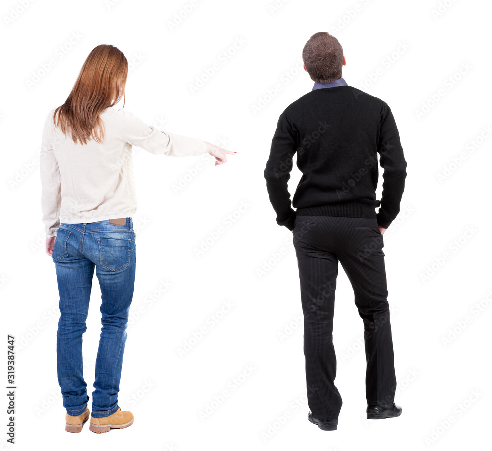 Back view of couple couple in sweater pointing. Back view of couple couple in sweater pointing.
