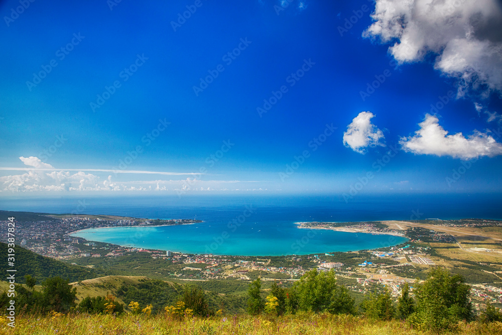 panorama of the resort city of Gelendzhik from the top of the Markoth ridge. You can see the round Gelendzhik Bay, the Black sea, the Thin and Thick Cape and the city lying on the shore of the Bay panorama of the resort city of Gelendzhik from the top of the Markoth ridge. You can see the round Gelendzhik Bay, the Black sea, the Thin and Thick Cape and the city lying on the shore of the Bay