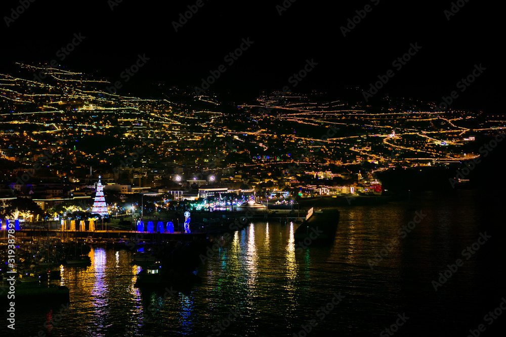 Funchal in Madeira, Portugal, with many lights at night, view from the sea