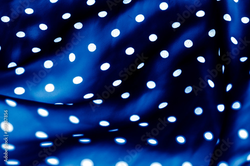 Classic polka dot textile background texture, white dots on blue luxury fabric design pattern photo