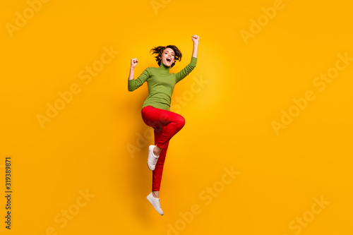 Full length photo of positive cheerful girl jump win season lottery discount enjoy rejoice raise fists scream yeah wear casual stylish clothing isolated over bright color background