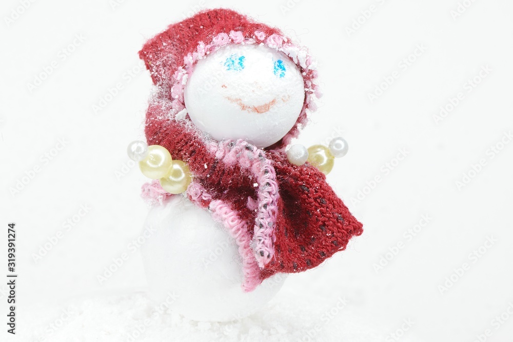 toy snowman in a red headdress and scarf toy snowman in a red headdress and scarf