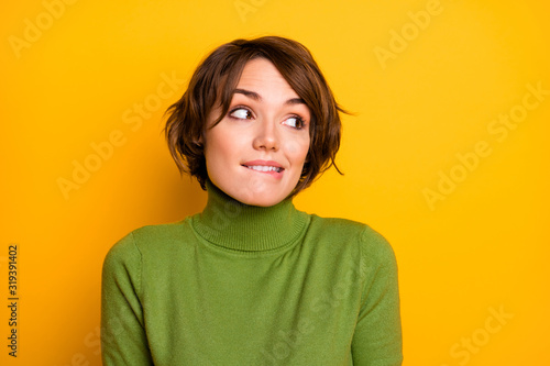 Oops. Closeup photo of beautiful lady ignoring expression said bad wrong thing look side empty space biting lips wear casual green turtleneck isolated yellow color background