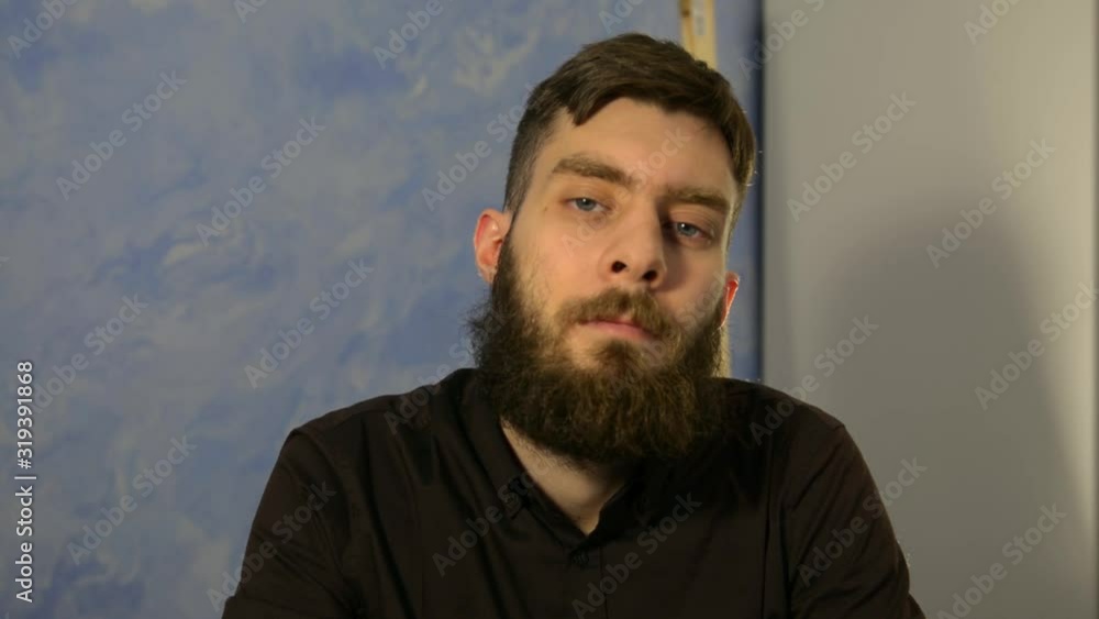 emotion. You guessed it. You're doing fine. Right choice. A man with a beard in a dark shirt shows emotion. emotion. You guessed it. You're doing fine. Right choice. A man with a beard in a dark shirt shows emotion.