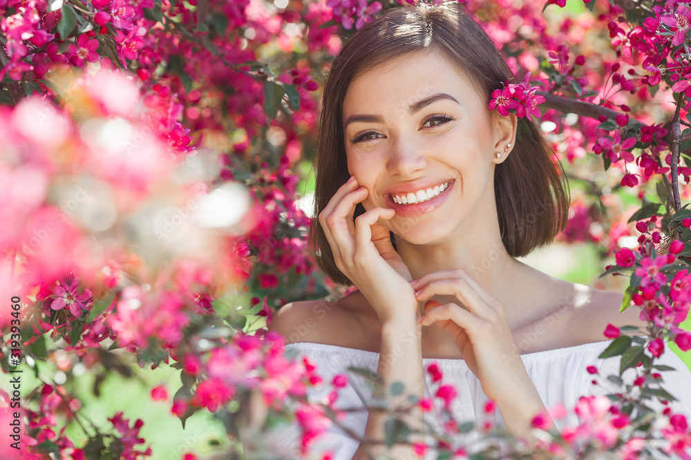 Beautiful lady on floral background. Woman with flowers. Poretait of gorgeous female in pink flowers. Beautiful lady on floral background. Woman with flowers. Poretait of gorgeous female in pink flowers.
