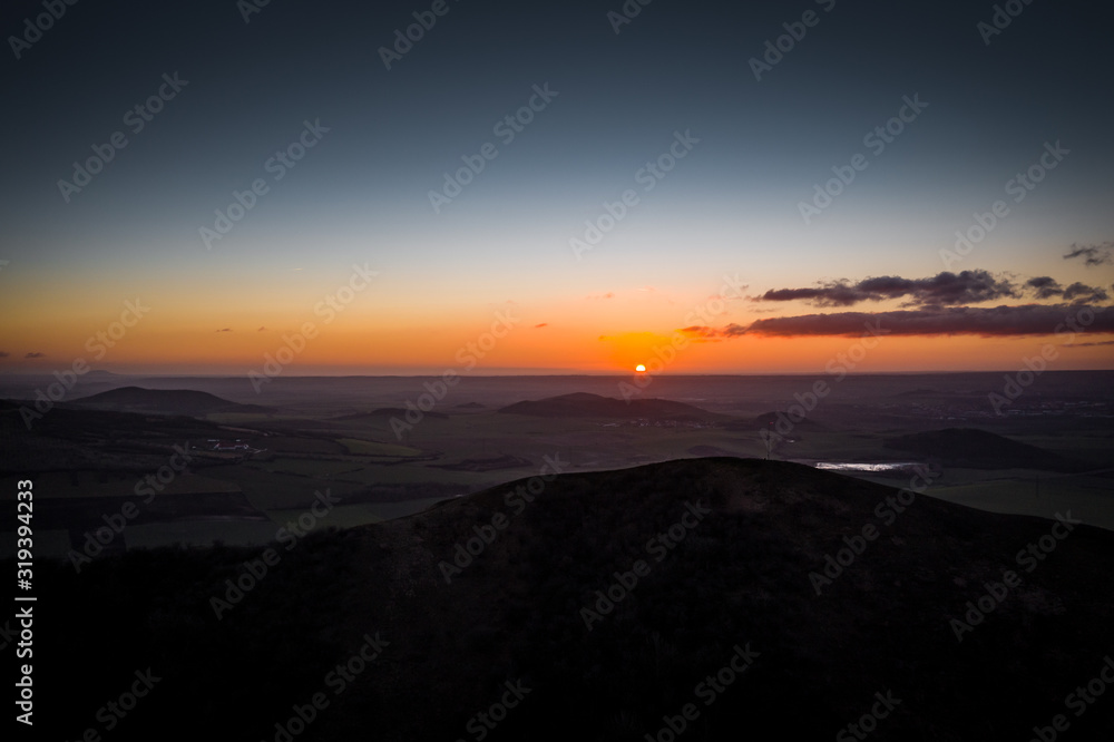Obraz premium Rana is a significant three-peak mountain 457m. in the western part of Ceske stredohori. The Rana National Nature Reserve is situated on the south-western hill of the trike, is the center of paraglide