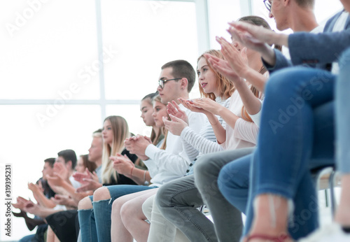 background image of young people applauding in the conference room